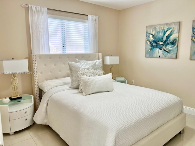 bedroom featuring baseboards and light tile patterned flooring