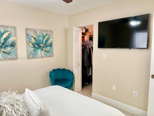 bedroom featuring baseboards, a spacious closet, and a closet