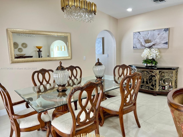 tiled dining space with arched walkways and visible vents
