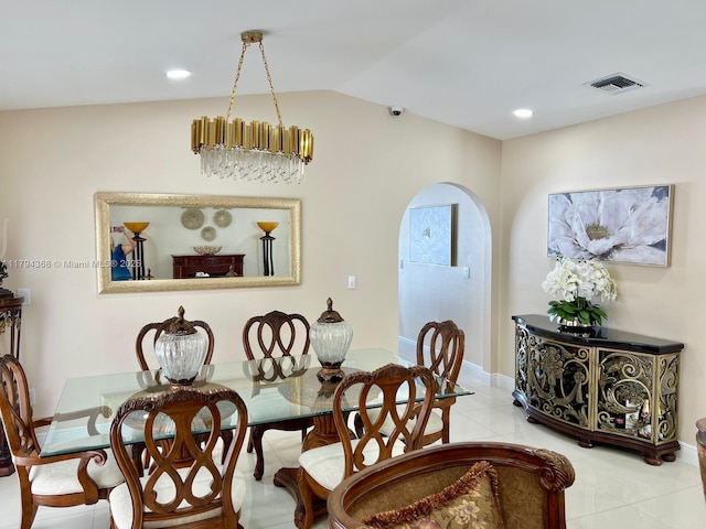 dining area featuring visible vents, lofted ceiling, baseboards, tile patterned floors, and arched walkways