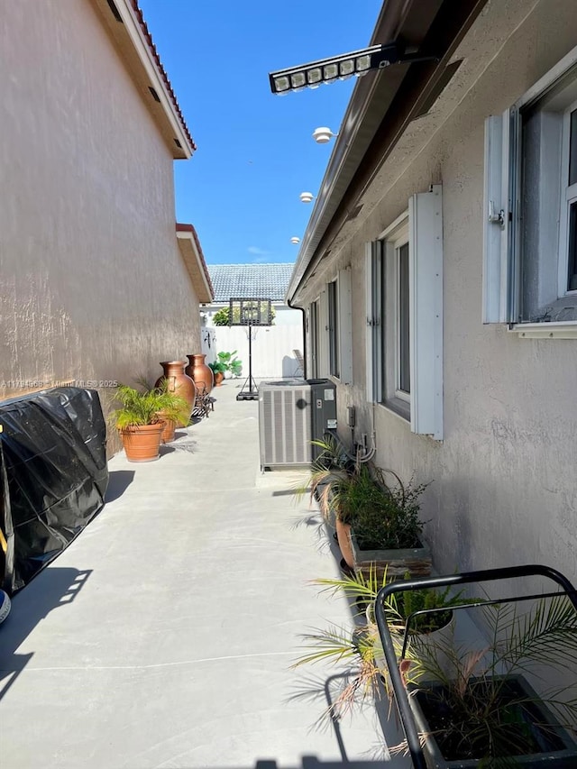 view of patio / terrace with fence and cooling unit