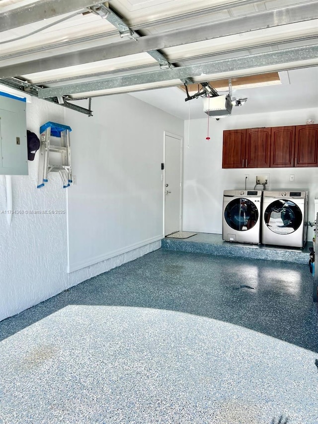 garage with baseboards, a garage door opener, electric panel, and washing machine and clothes dryer