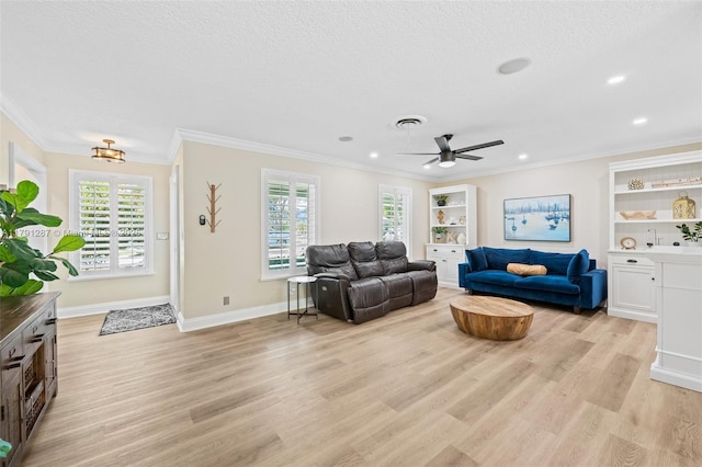 living area featuring plenty of natural light, ornamental molding, and light wood-type flooring