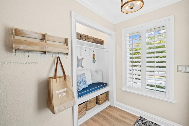 mudroom featuring baseboards, a notable chandelier, ornamental molding, and wood finished floors