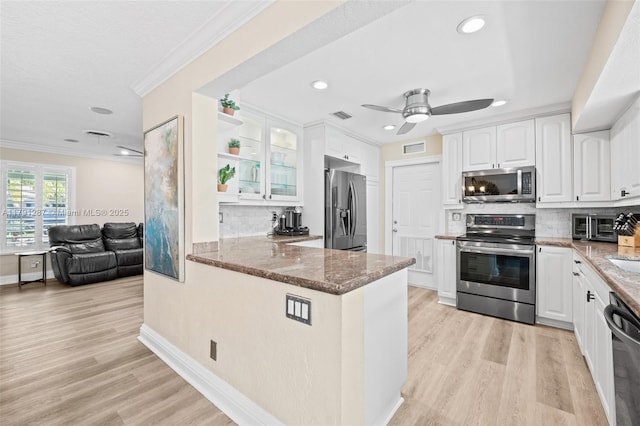 kitchen featuring stainless steel appliances, stone countertops, white cabinetry, and visible vents