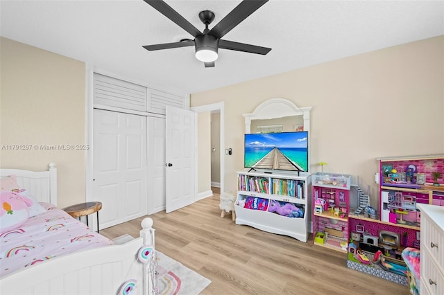 bedroom featuring a ceiling fan, a closet, and wood finished floors