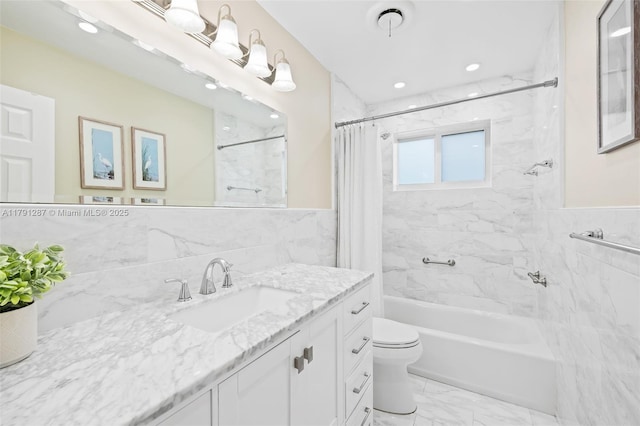 bathroom with shower / bath combo with shower curtain, vanity, marble finish floor, toilet, and tile walls
