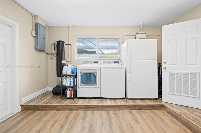 laundry room featuring independent washer and dryer, laundry area, wood finished floors, visible vents, and electric panel