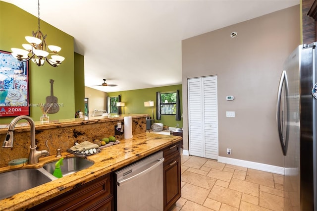 563 Lakeside Cir, Sunrise, FL 33326 - kitchen featuring stainless steel appliances, a sink, a chandelier, baseboards, and decorative light fixtures