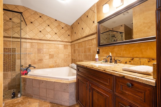 563 Lakeside Cir, Sunrise, FL 33326 - full bath featuring tile walls, a stall shower, a bath, vanity, and vaulted ceiling
