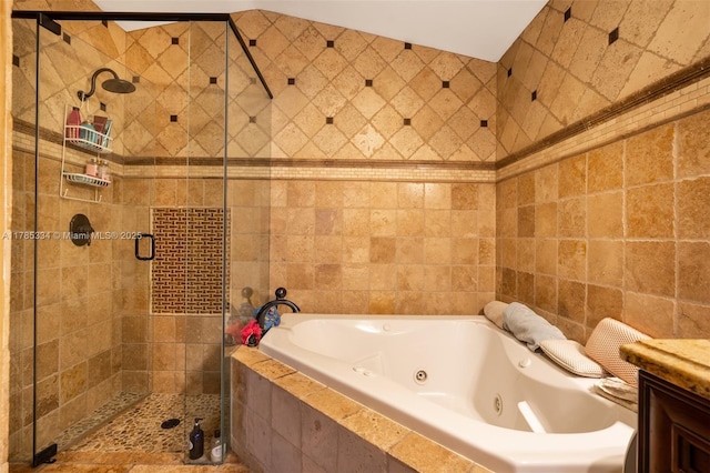 563 Lakeside Cir, Sunrise, FL 33326 - bathroom with a tub with jets, a stall shower, tile walls, and vanity