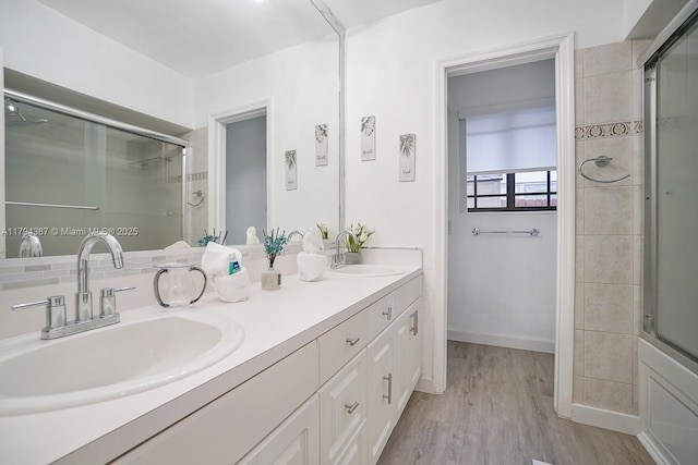 850 NE 182nd Ter, North Miami Beach, FL 33162 - full bathroom featuring double vanity, a shower with door, a sink, and wood finished floors