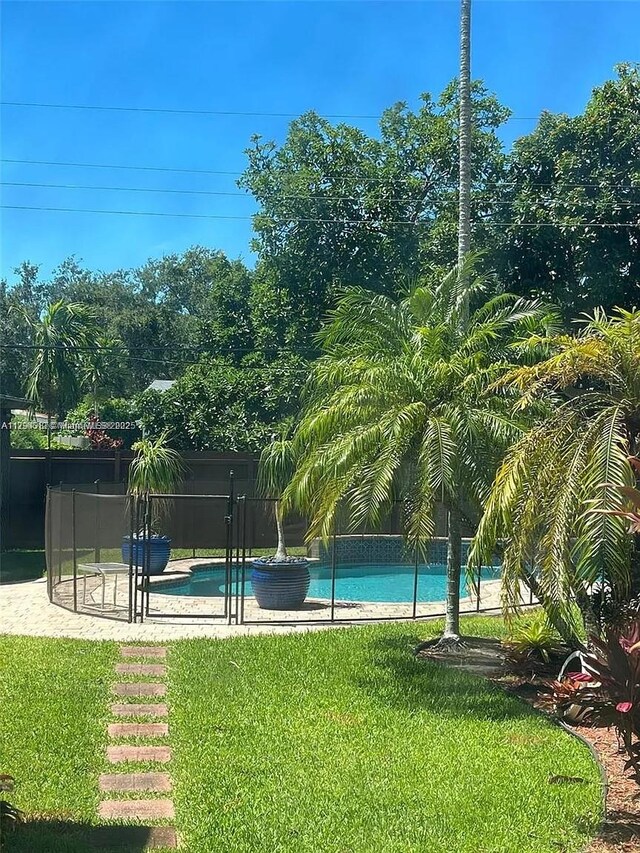 850 NE 182nd Ter, North Miami Beach, FL 33162 - outdoor pool featuring a lawn
