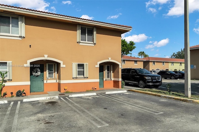 view of property with uncovered parking