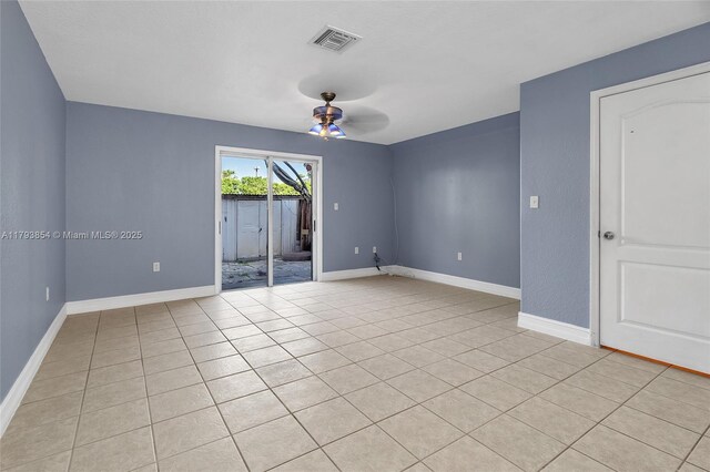 spare room with light tile patterned floors, baseboards, a ceiling fan, and visible vents
