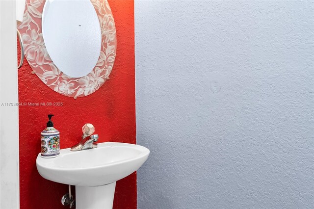 bathroom with a sink and a textured wall