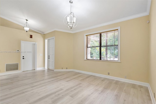 empty room with baseboards, ornamental molding, light wood finished floors, and visible vents