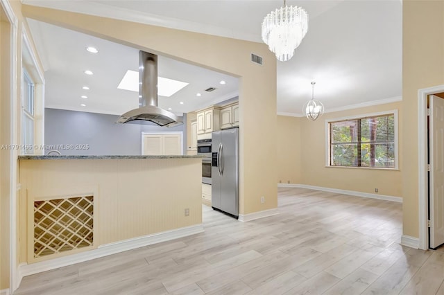 kitchen featuring island range hood, a notable chandelier, stainless steel fridge, and ornamental molding