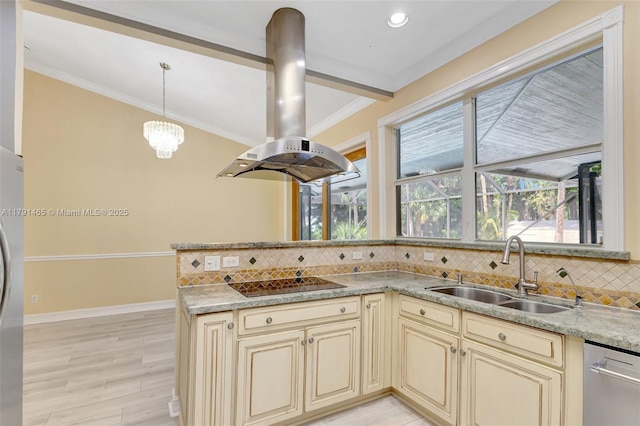 kitchen with decorative backsplash, island range hood, cream cabinets, a sink, and appliances with stainless steel finishes