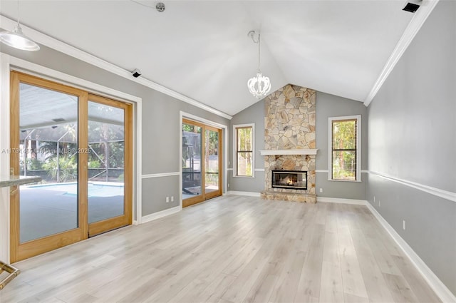 unfurnished living room featuring a chandelier, lofted ceiling, ornamental molding, and light wood finished floors