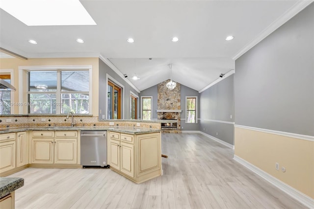 16789 98th Way N, Jupiter, FL 33478 - kitchen with cream cabinets, stainless steel dishwasher, light wood-style floors, open floor plan, and light stone counters