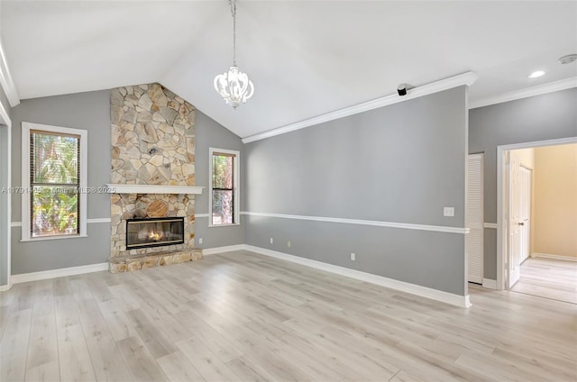 unfurnished living room with plenty of natural light, wood finished floors, and a chandelier