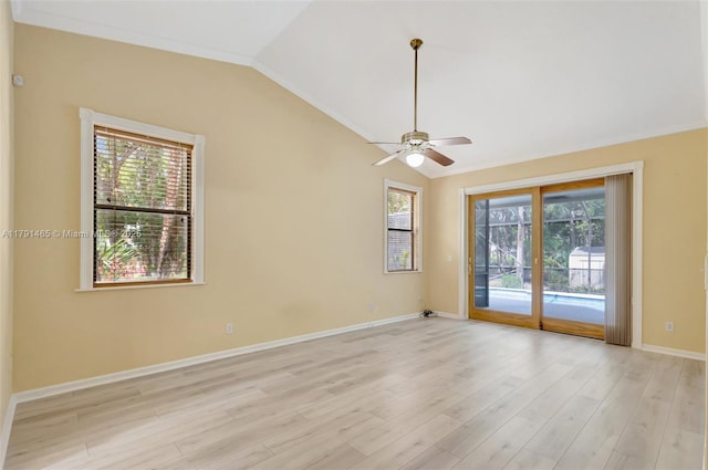 spare room with light wood-style floors, baseboards, a ceiling fan, and lofted ceiling