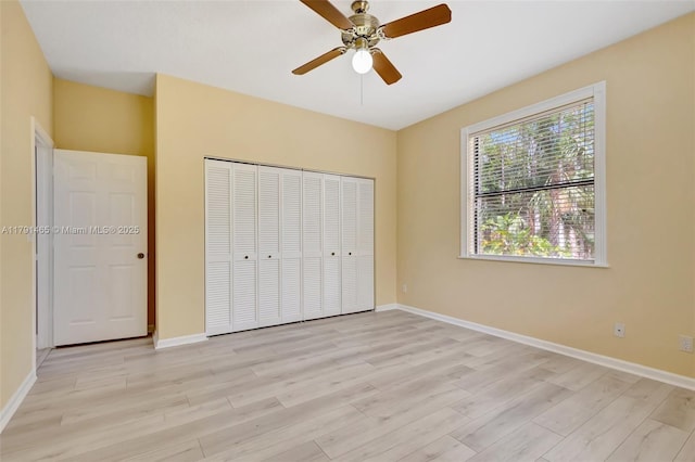 16789 98th Way N, Jupiter, FL 33478 - unfurnished bedroom featuring light wood finished floors, baseboards, a closet, and a ceiling fan