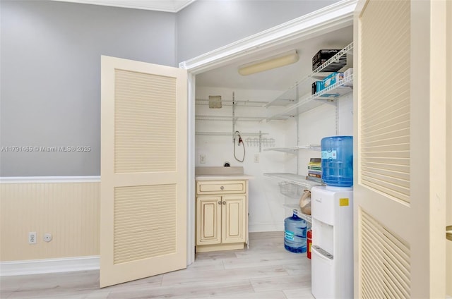 laundry area featuring baseboards and light wood-style flooring
