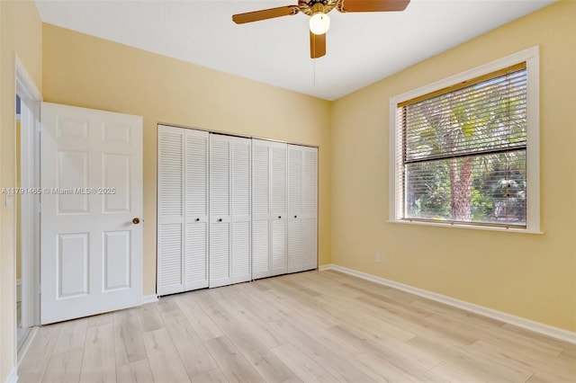 16789 98th Way N, Jupiter, FL 33478 - unfurnished bedroom featuring light wood-style flooring, baseboards, a closet, and a ceiling fan