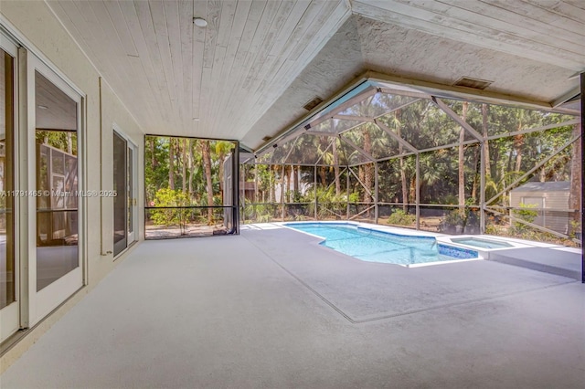 16789 98th Way N, Jupiter, FL 33478 - view of swimming pool featuring a patio area, a pool with connected hot tub, and glass enclosure