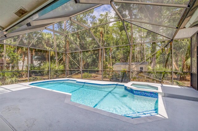 16789 98th Way N, Jupiter, FL 33478 - view of pool with a patio area, a pool with connected hot tub, an outbuilding, a storage shed, and glass enclosure