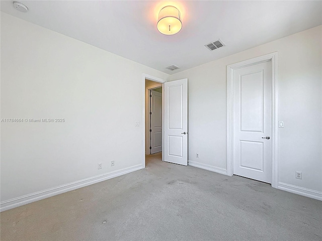 unfurnished bedroom featuring visible vents, baseboards, and carpet floors