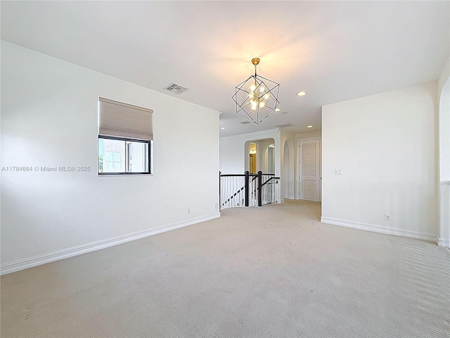 unfurnished room with arched walkways, baseboards, recessed lighting, and visible vents