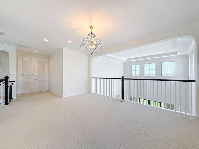 unfurnished room with arched walkways, carpet, and recessed lighting