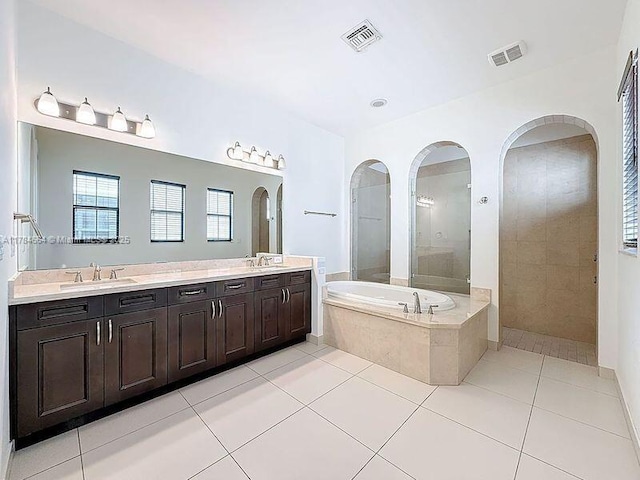 bathroom featuring a sink, a garden tub, and visible vents