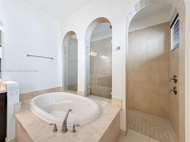 full bath with a garden tub, a tile shower, and vanity
