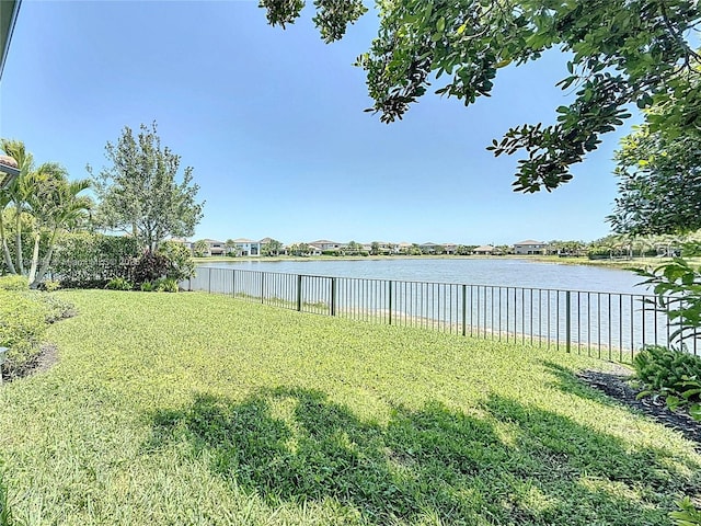 view of yard with fence and a water view