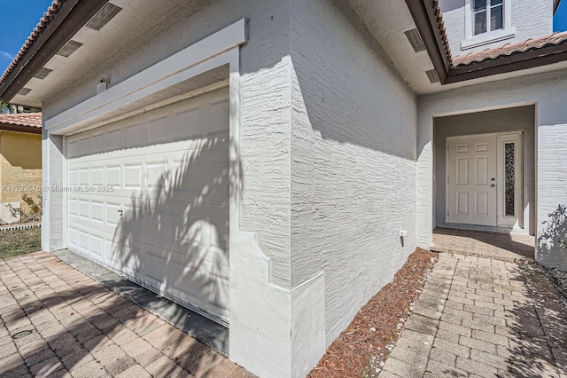 1107 NE 41st Ave, Homestead, FL 33033 - exterior space featuring a garage, a tile roof, and stucco siding