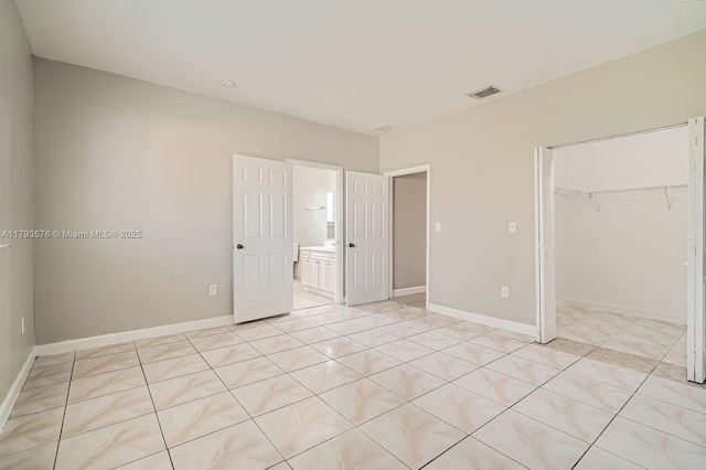 unfurnished bedroom with baseboards, visible vents, and a closet