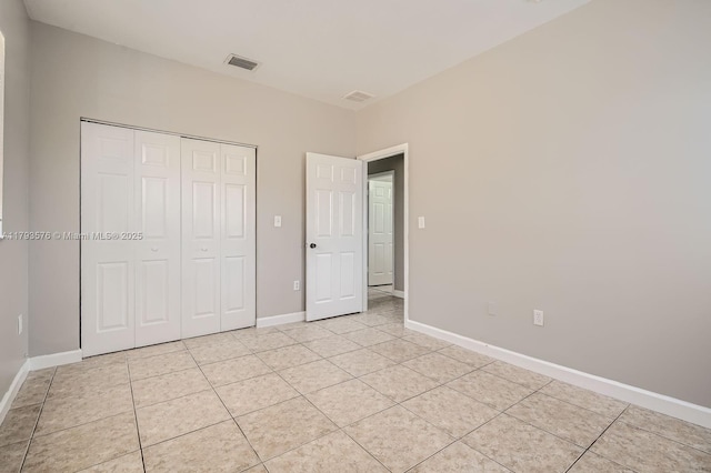 1107 NE 41st Ave, Homestead, FL 33033 - unfurnished bedroom with baseboards, light tile patterned flooring, a closet, and visible vents