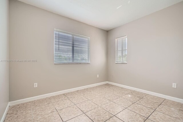 1107 NE 41st Ave, Homestead, FL 33033 - unfurnished room with baseboards and light tile patterned floors