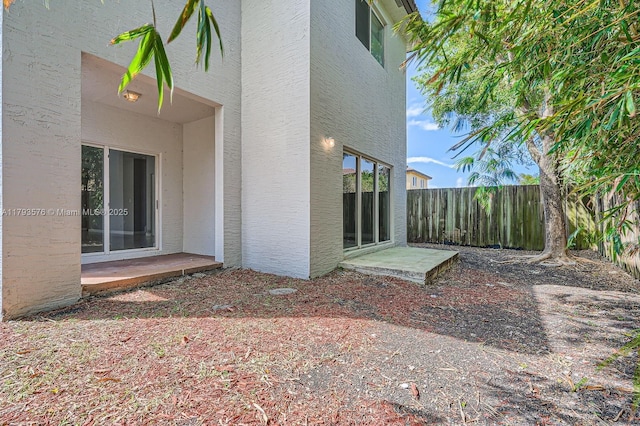 exterior space with fence and stucco siding