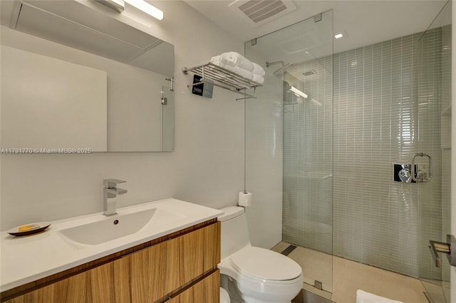 bathroom featuring vanity, toilet, and a stall shower