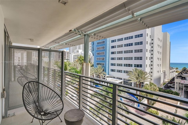 balcony featuring a water view and a view of city