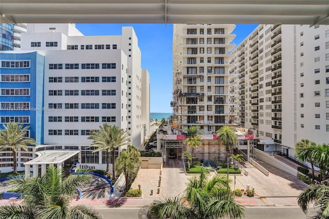 view of building exterior with a water view and a view of city