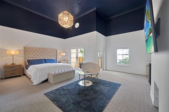 bedroom featuring crown molding, a high ceiling, a notable chandelier, carpet floors, and baseboards