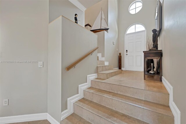 entryway with baseboards and stairs