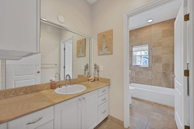 bathroom featuring bathtub / shower combination, vanity, toilet, tile patterned floors, and baseboards