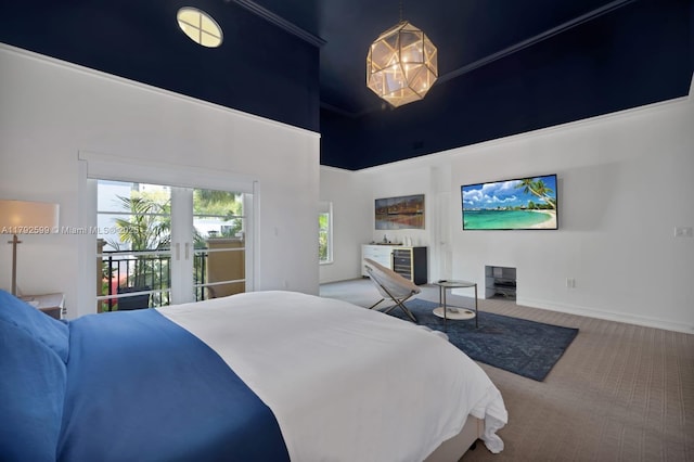 carpeted bedroom featuring baseboards, a towering ceiling, and access to exterior